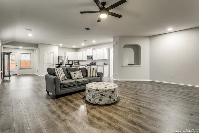 a living room with furniture and a chandelier