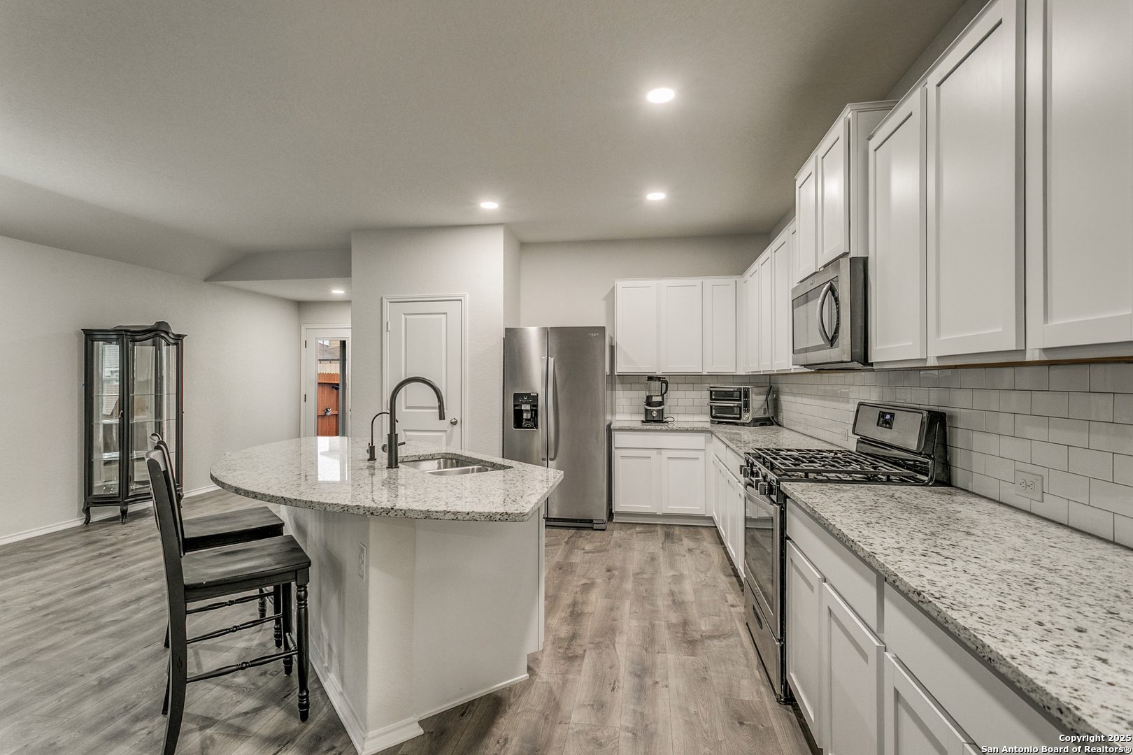 29632 Winter Copper Bulverde, TX 78163 - Photo 10 of 26 a kitchen with stainless steel appliances granite countertop a sink a stove top oven a counter space and cabinets