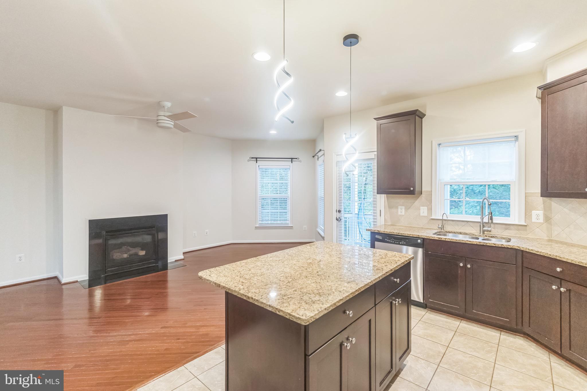 42385 Trellis Square Brambleton, VA 20148 - Photo 13 of 28 a kitchen with stainless steel appliances granite countertop a sink and a refrigerator