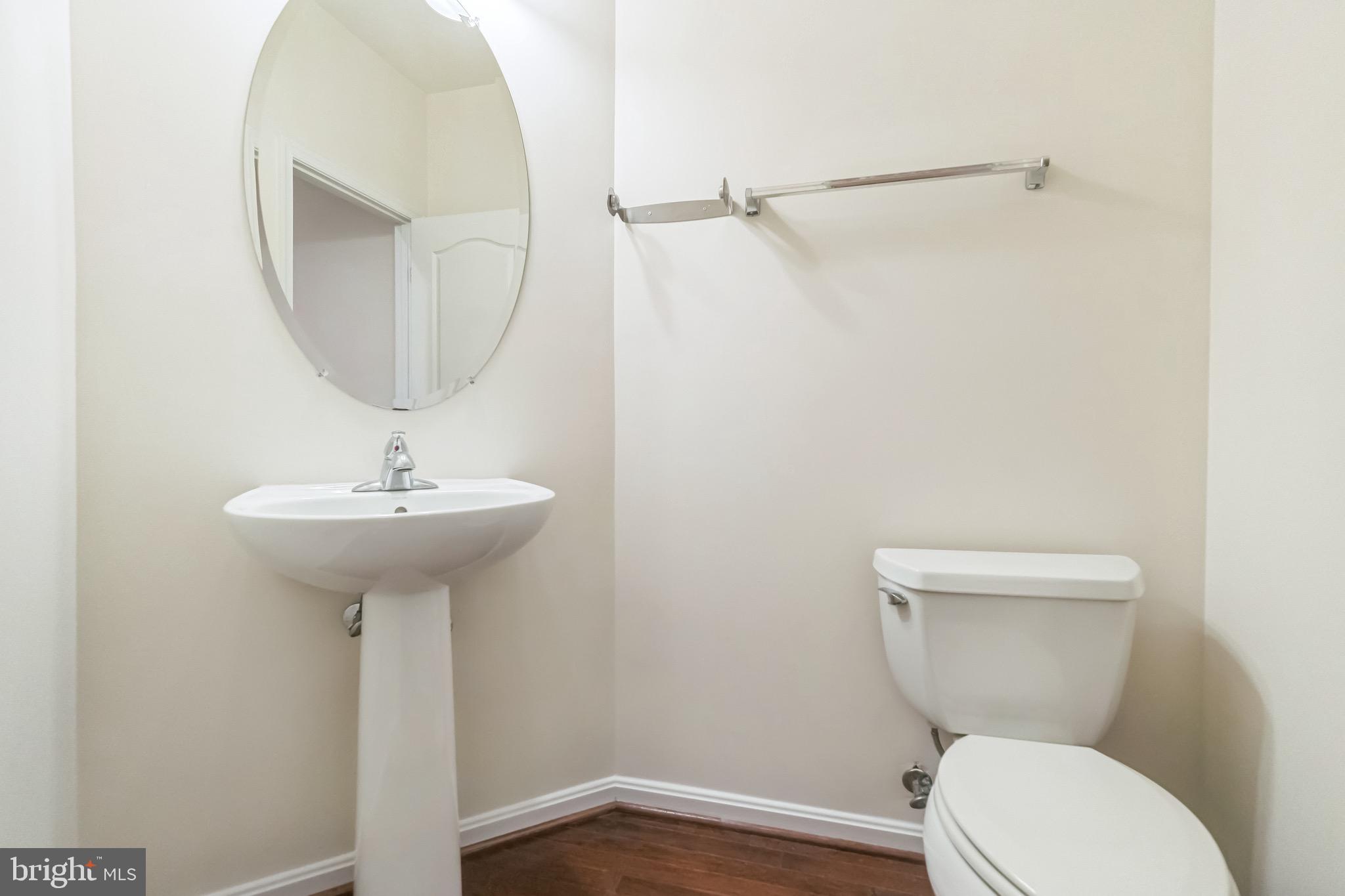 42385 Trellis Square Brambleton, VA 20148 - Photo 14 of 28 a bathroom with a toilet sink and mirror