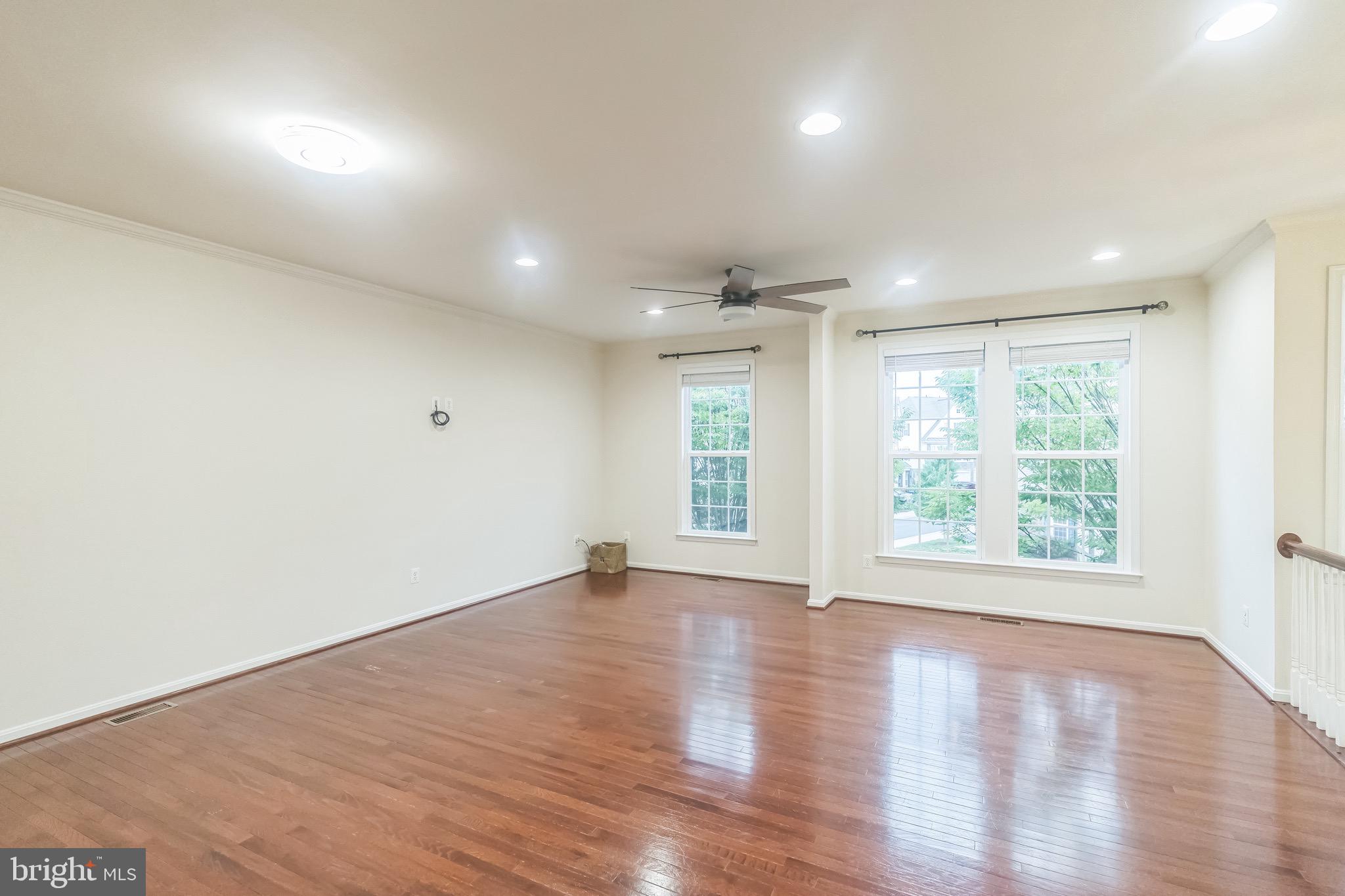 42385 Trellis Square Brambleton, VA 20148 - Photo 15 of 28 an empty room with wooden floor and windows