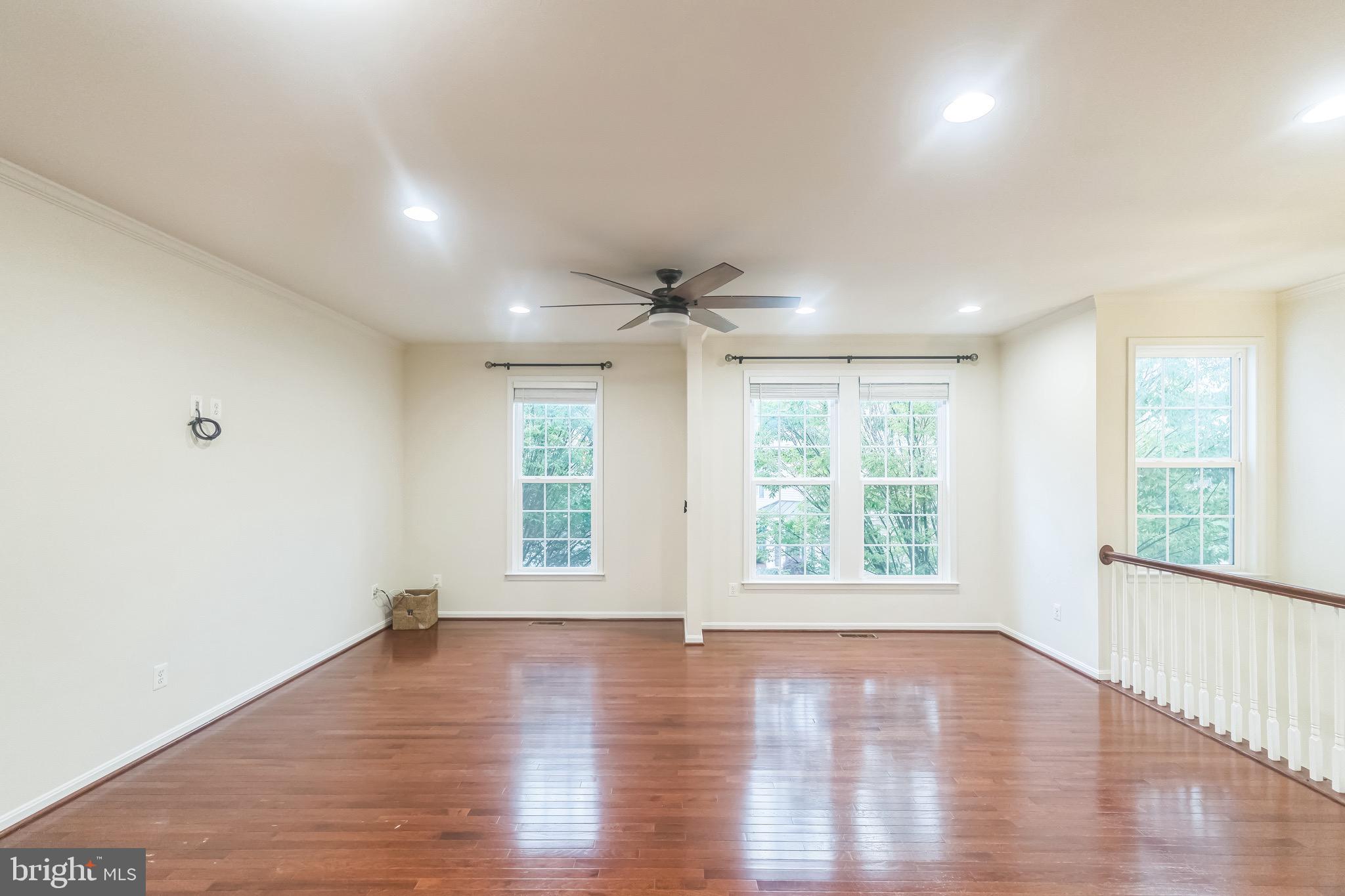 42385 Trellis Square Brambleton, VA 20148 - Photo 16 of 28 a view of an empty room with wooden floor and a window