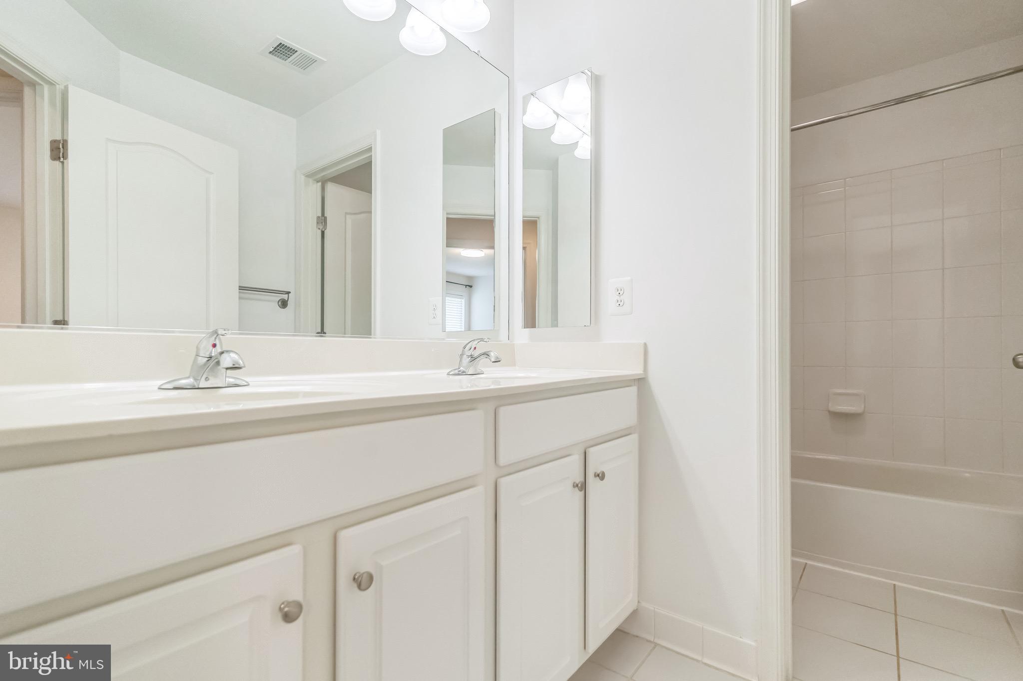 42385 Trellis Square Brambleton, VA 20148 - Photo 24 of 28 a bathroom with a sink and a mirror