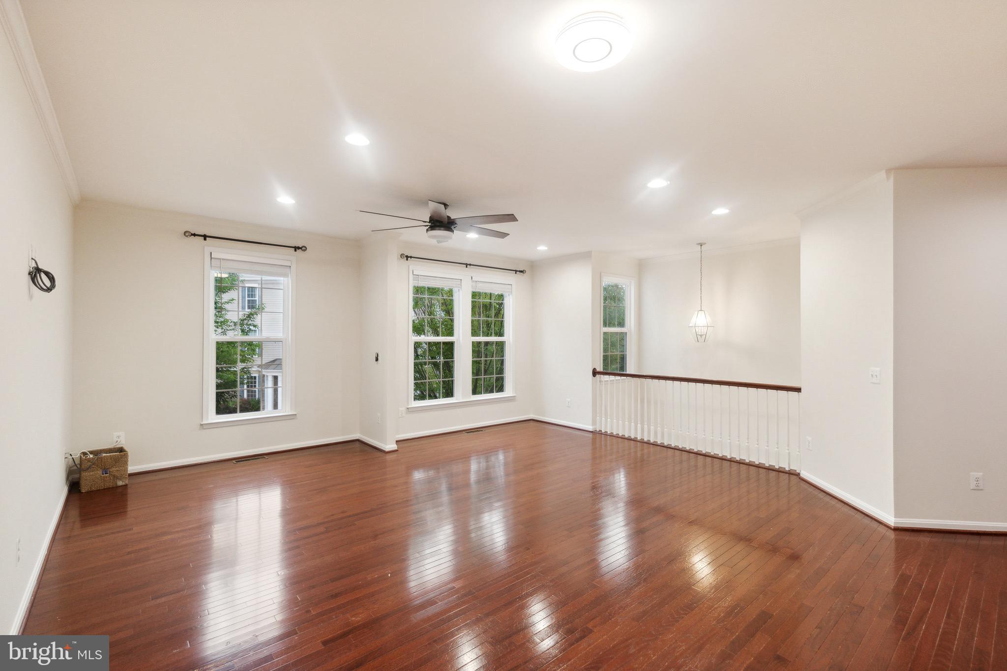 42385 Trellis Square Brambleton, VA 20148 - Photo 8 of 28 a view of an empty room with wooden floor and a window