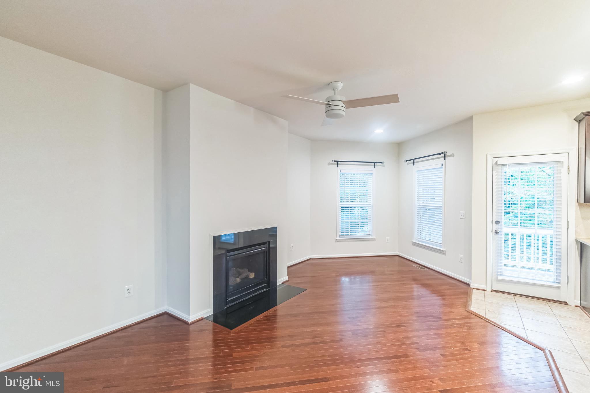 42385 Trellis Square Brambleton, VA 20148 - Photo 9 of 28 a view of an empty room with wooden floor and a window