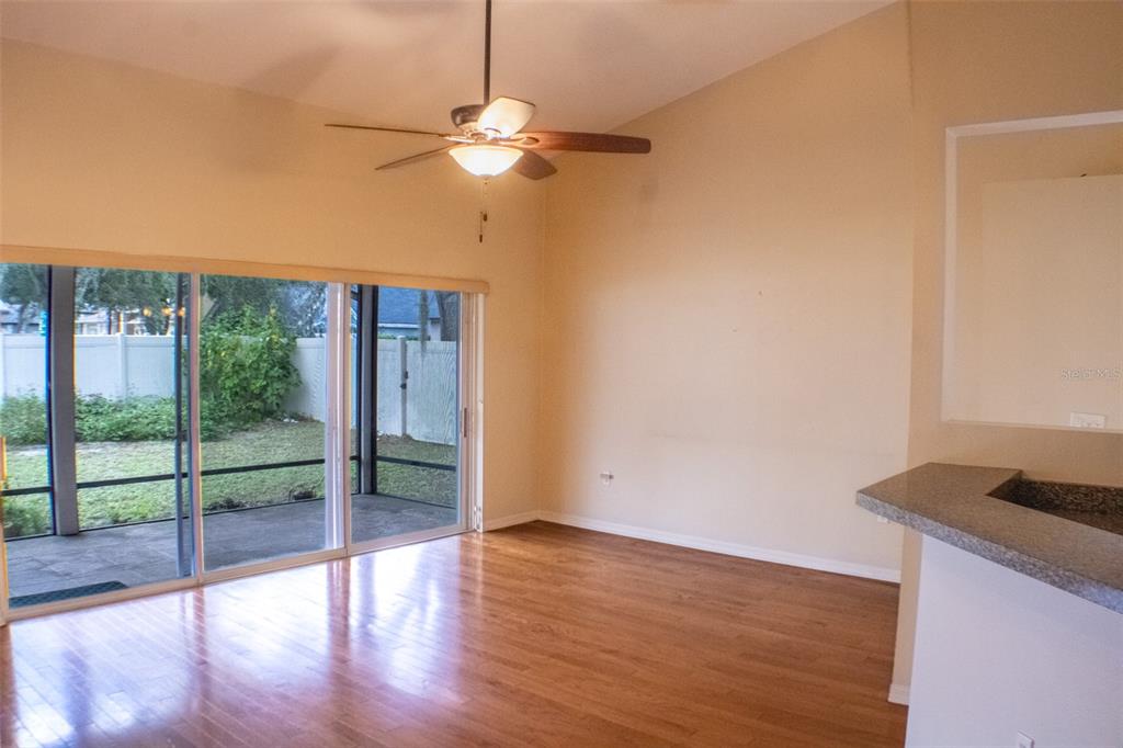 601 Shady Point Way DeLand, FL 32724 - Photo 12 of 36 a view of an empty room with wooden floor and a window