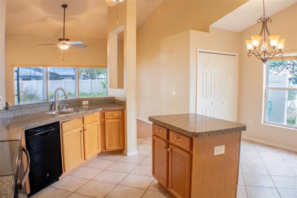 601 Shady Point Way DeLand, FL 32724 - Photo 17 of 36 a kitchen with stainless steel appliances granite countertop a sink a counter space and a window