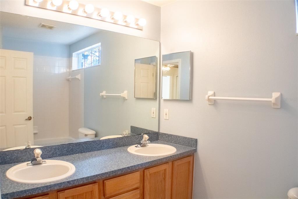 601 Shady Point Way DeLand, FL 32724 - Photo 28 of 36 a bathroom with a sink and a mirror