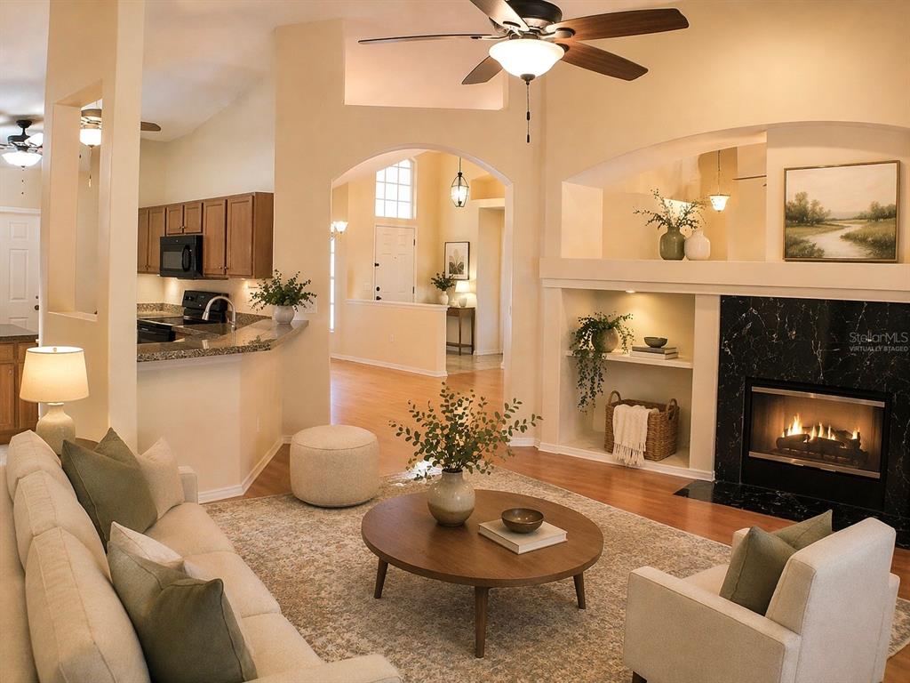 601 Shady Point Way DeLand, FL 32724 - Photo 4 of 36 a living room with furniture and a fireplace