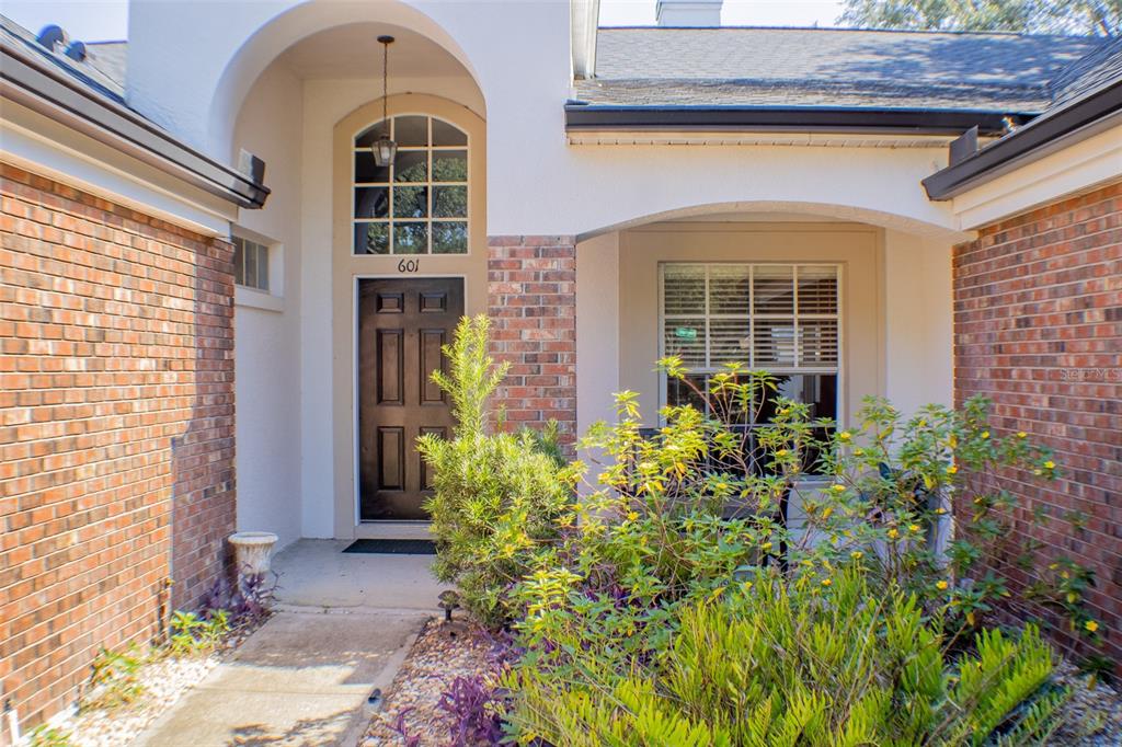 601 Shady Point Way Deland, FL 32724 - Photo 4 of 33 a front view of a house with a garden