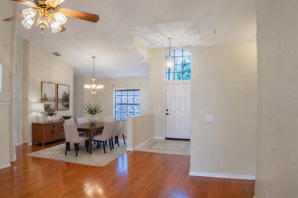 601 Shady Point Way DeLand, FL 32724 - Photo 6 of 36 a view of a dining room with furniture and chandelier