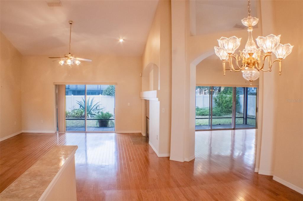 601 Shady Point Way Deland, FL 32724 - Photo 7 of 33 wooden floor in an empty room with a window