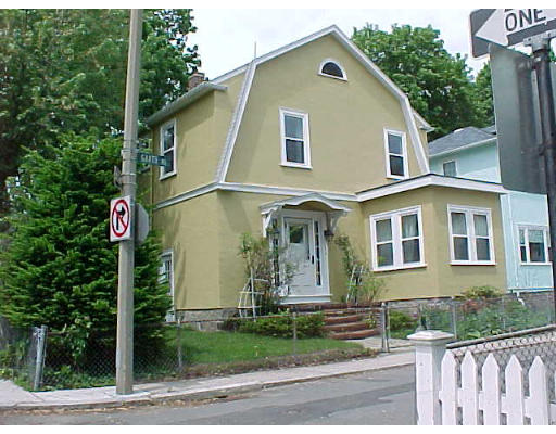 22 Garth Road Boston, MA 02132 - Photo 2 of 2 a front view of a house with garden