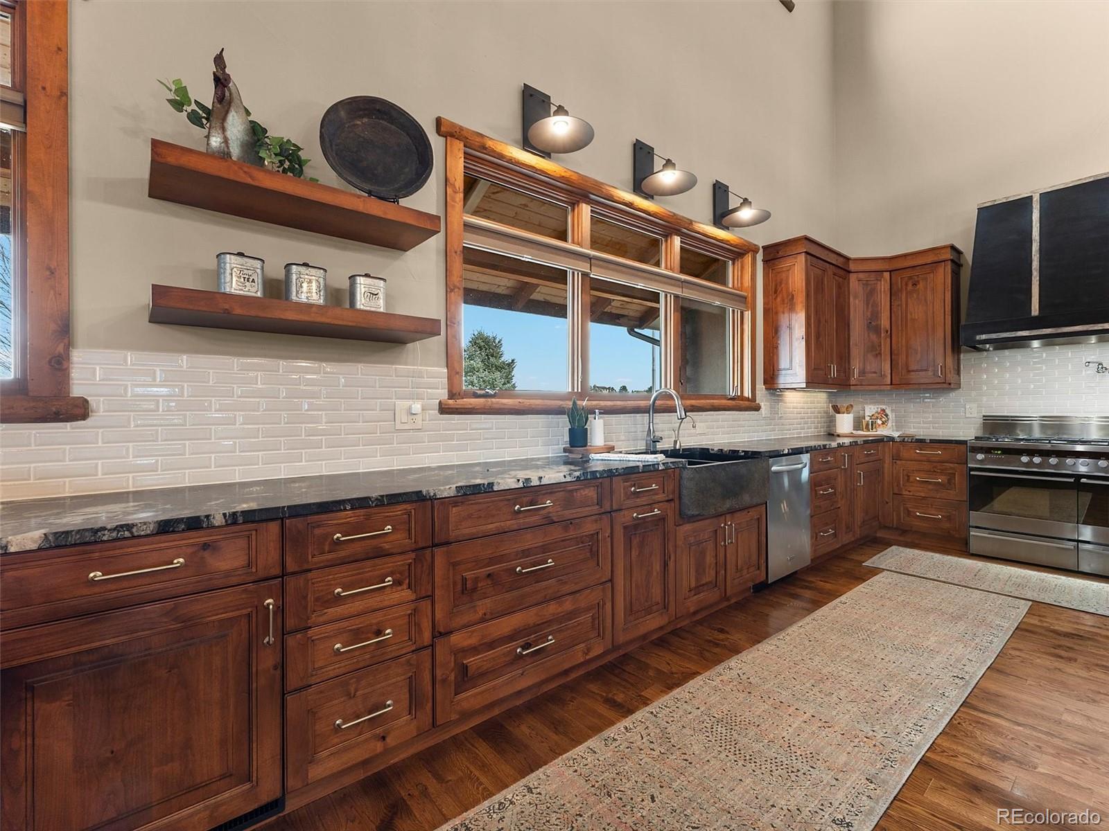 934 South Perry Park Road Sedalia, CO 80135 - Photo 11 of 48 a kitchen with stainless steel appliances granite countertop a sink and cabinets