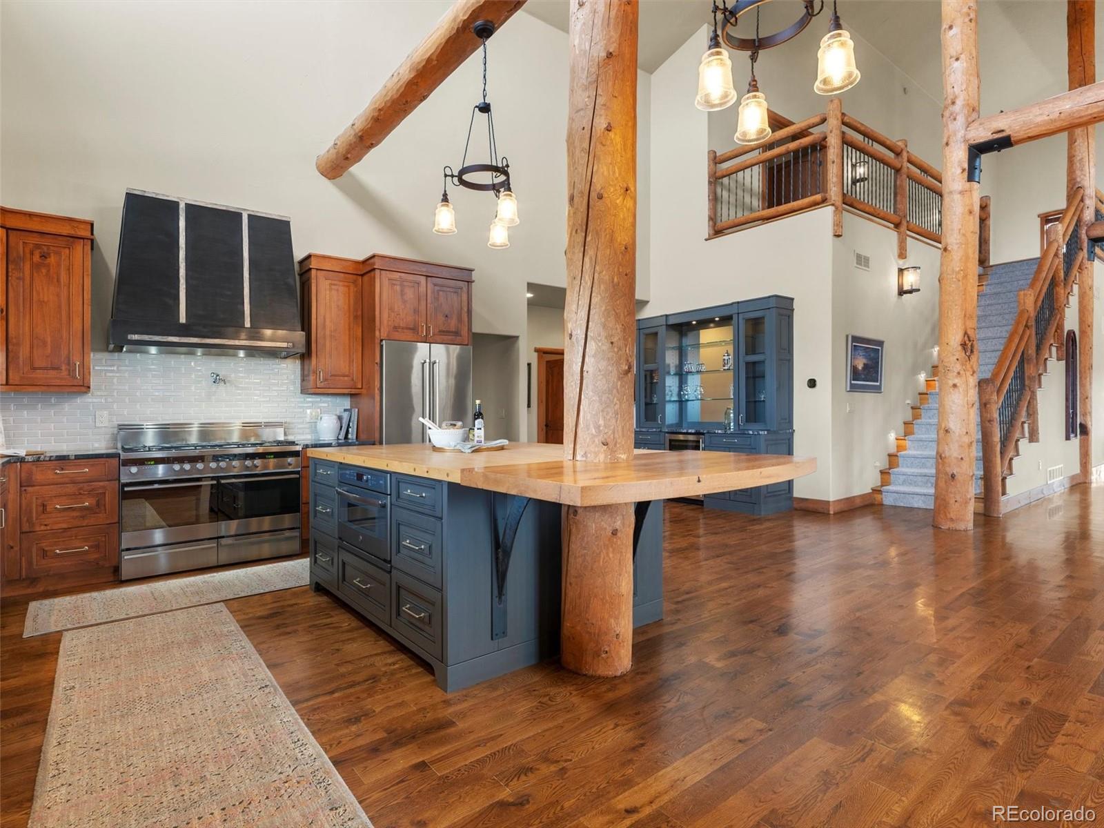 934 South Perry Park Road Sedalia, CO 80135 - Photo 12 of 48 a kitchen with stainless steel appliances granite countertop a stove a sink and a refrigerator