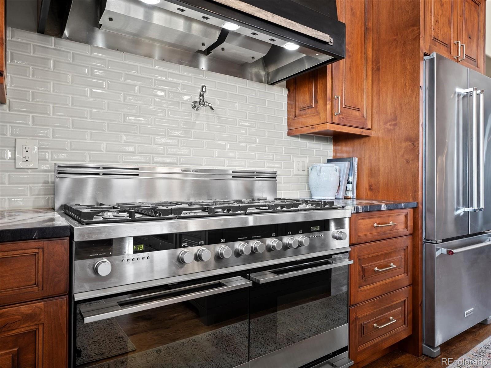 934 South Perry Park Road Sedalia, CO 80135 - Photo 14 of 48 a stove top oven sitting inside of a kitchen