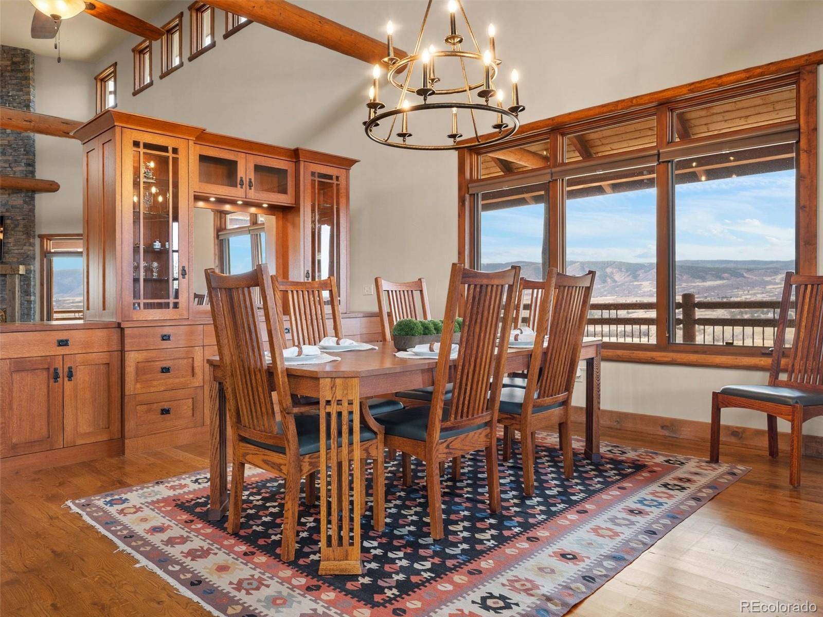 934 South Perry Park Road Sedalia, CO 80135 - Photo 15 of 48 a view of a dining room with furniture window and wooden floor