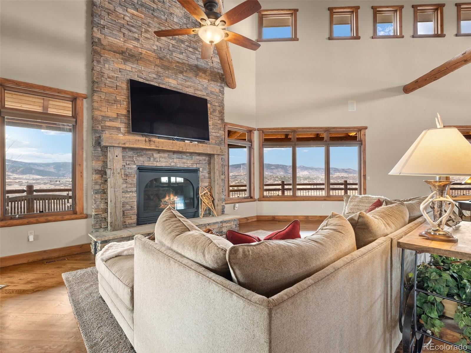 934 South Perry Park Road Sedalia, CO 80135 - Photo 18 of 48 a living room with furniture fireplace and flat screen tv