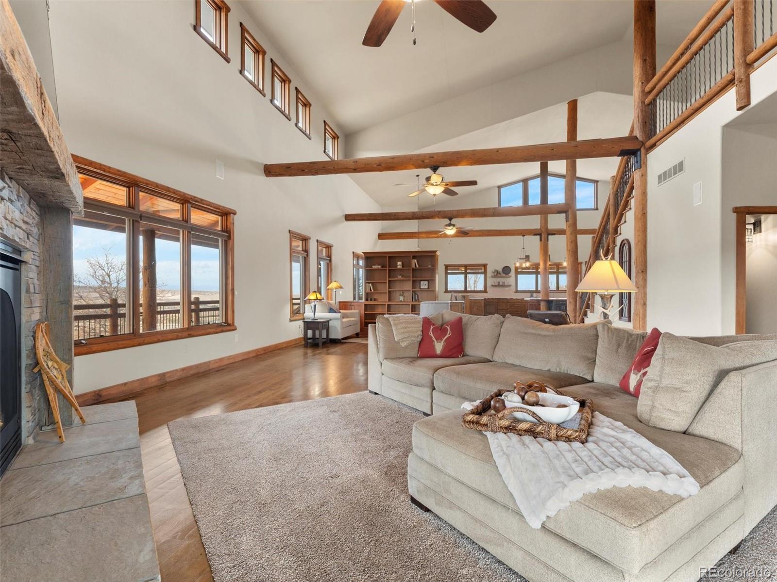 934 South Perry Park Road Sedalia, CO 80135 - Photo 19 of 48 a living room with furniture and a floor to ceiling window