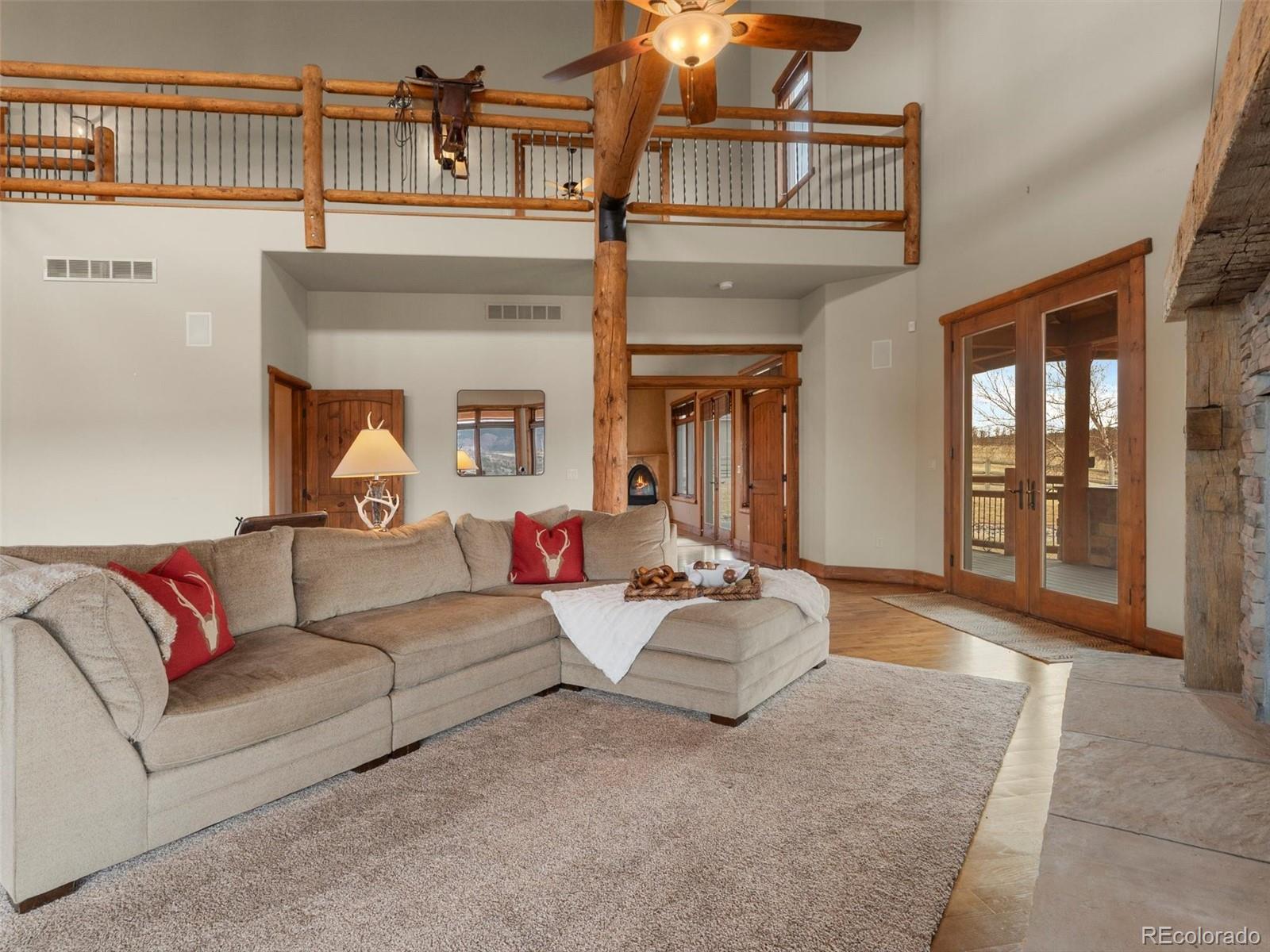 934 South Perry Park Road Sedalia, CO 80135 - Photo 20 of 48 a living room with furniture and a fireplace