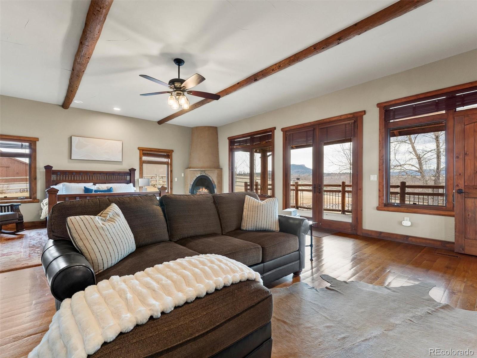 934 South Perry Park Road Sedalia, CO 80135 - Photo 22 of 48 a living room with furniture and a large window with kitchen view
