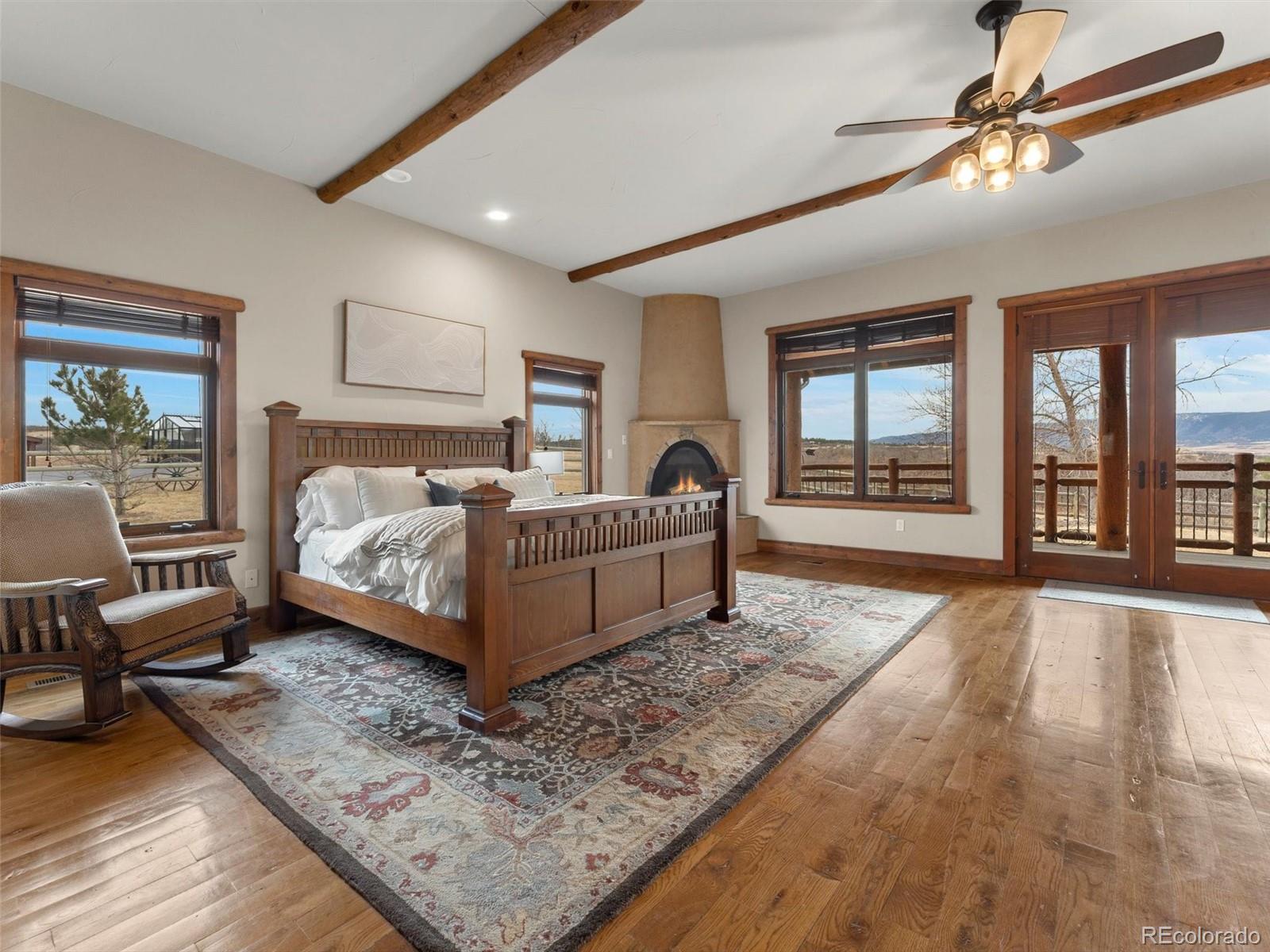 934 South Perry Park Road Sedalia, CO 80135 - Photo 23 of 48 a living room with a bed furniture and next to a window