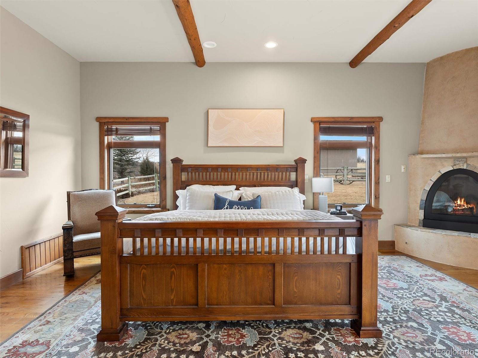 934 South Perry Park Road Sedalia, CO 80135 - Photo 25 of 48 a bedroom with a bed and a table in it