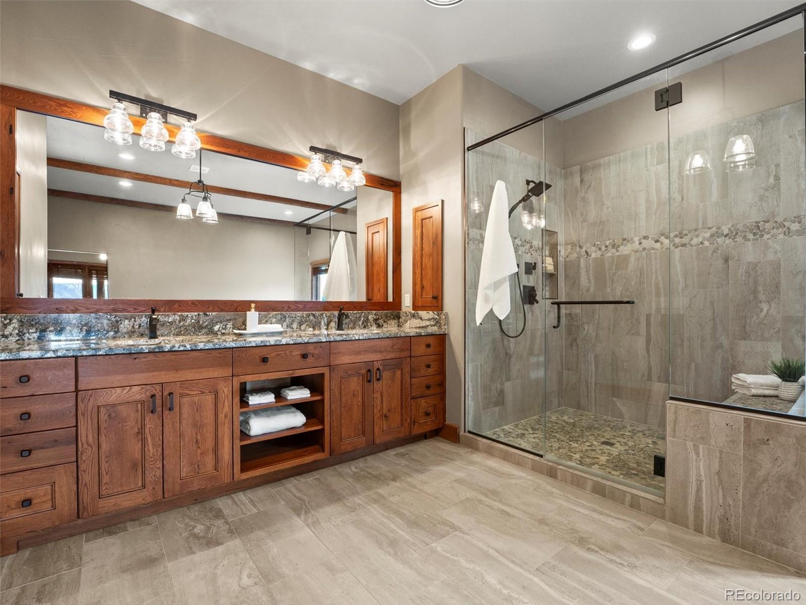 934 South Perry Park Road Sedalia, CO 80135 - Photo 27 of 48 a bathroom with a sink a toilet and shower