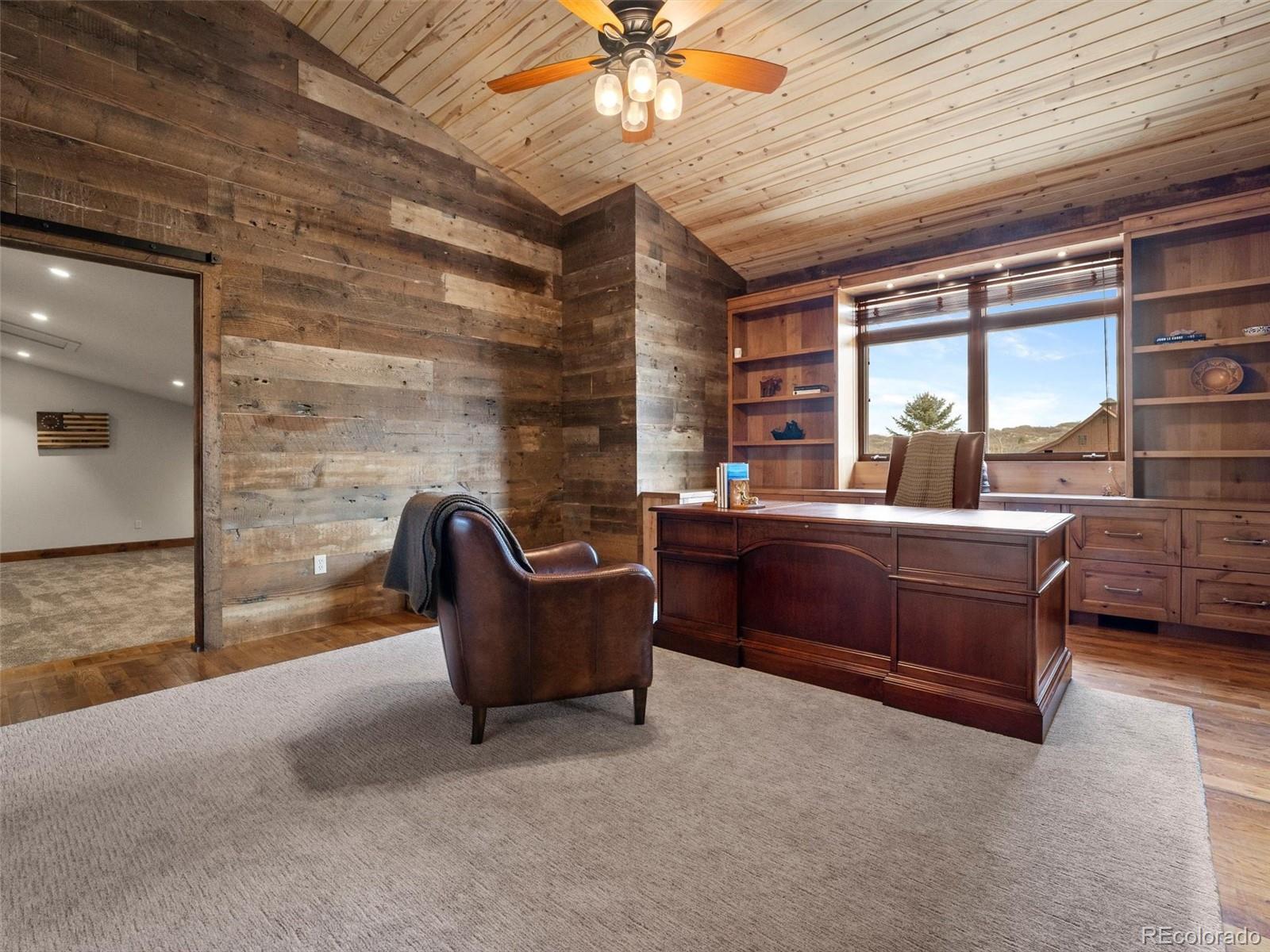 934 South Perry Park Road Sedalia, CO 80135 - Photo 35 of 48 a living room with furniture and a fireplace