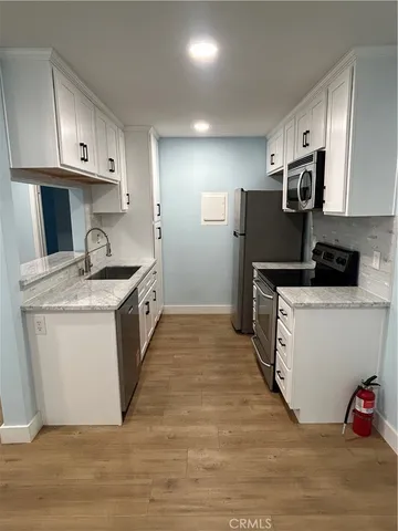 a kitchen with a sink stove and cabinets