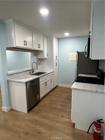 a kitchen with stainless steel appliances granite countertop a sink and a stove