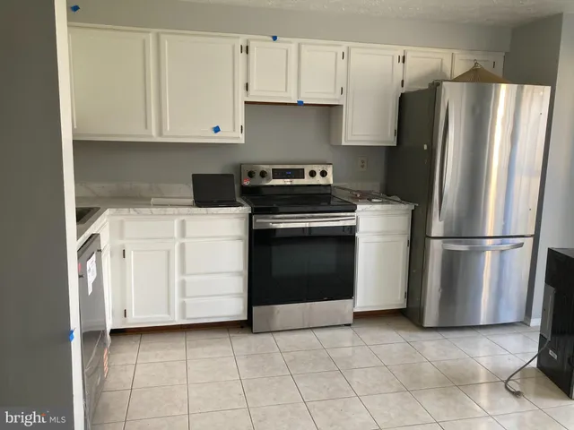 a kitchen with appliances cabinets and a window