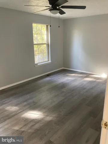 a view of an empty room and a window