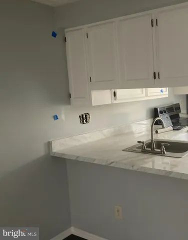 a kitchen with a sink and cabinets