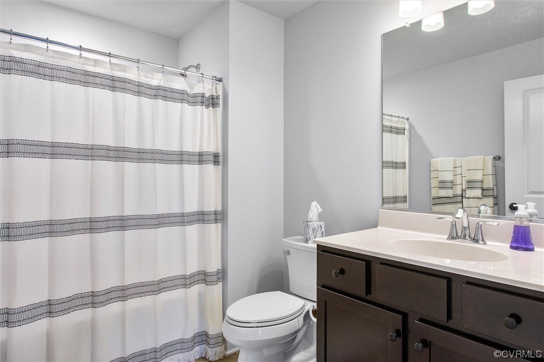 119 Evington Lane Ashland, VA 23005 - Photo 15 of 18 a bathroom with a sink a toilet a mirror and shower
