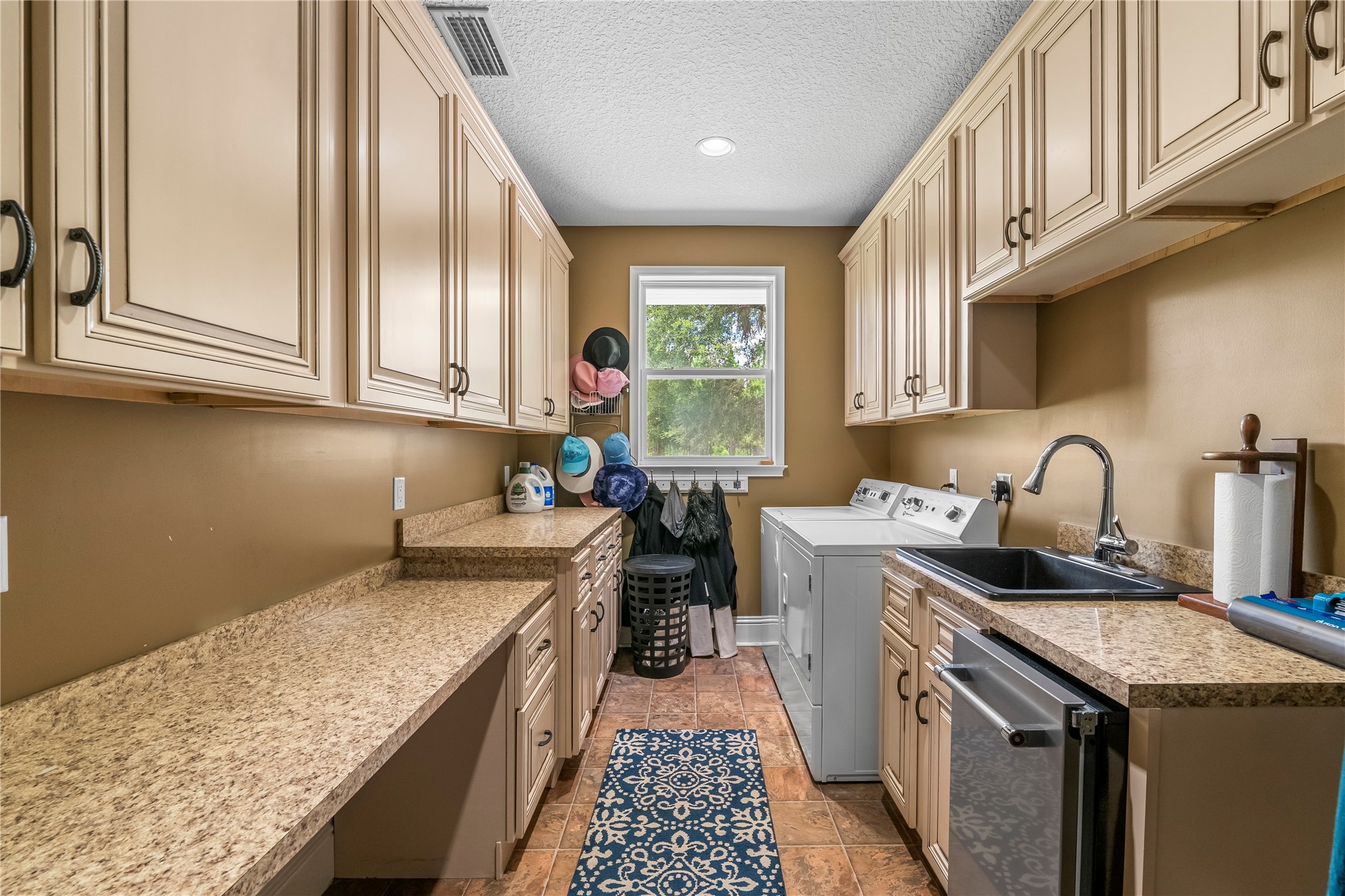 27247 Hallman Road Hilliard, FL 32046 - Photo 42 of 59 a kitchen with a sink stove and cabinets