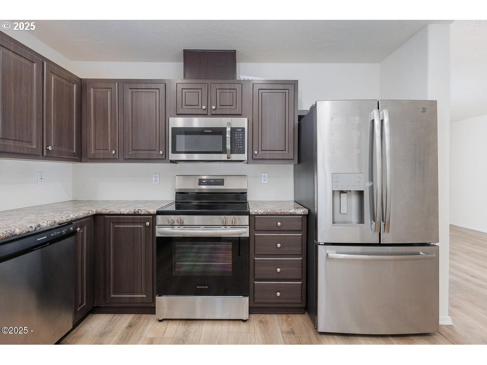 150 Northwest 5th Street Toledo, OR 97391 - Photo 11 of 26 a kitchen with cabinets stainless steel appliances and a sink