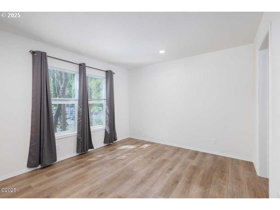 150 Northwest 5th Street Toledo, OR 97391 - Photo 12 of 26 a view of an empty room with wooden floor and a window