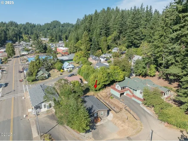 an aerial view of a house with a yard
