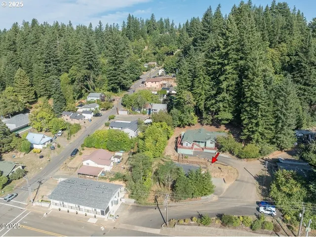an aerial view of a houses with yard