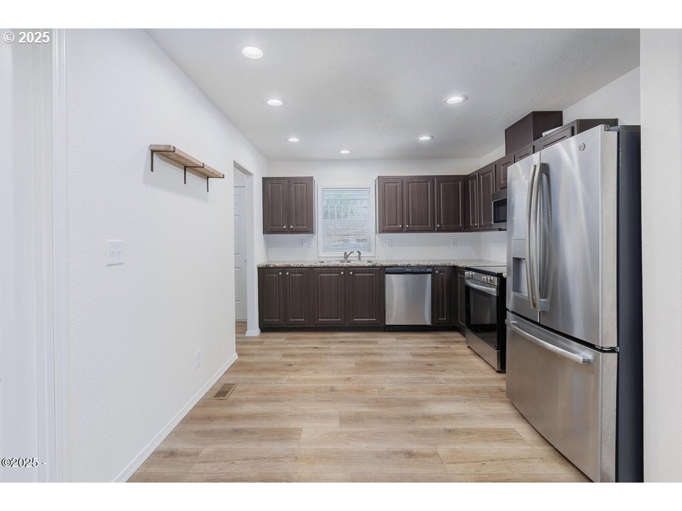 150 Northwest 5th Street Toledo, OR 97391 - Photo 6 of 26 a kitchen with stainless steel appliances a refrigerator and a stove