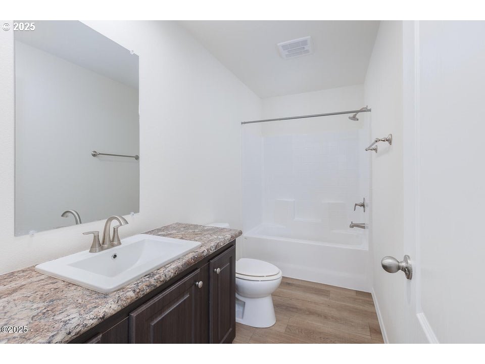 150 Northwest 5th Street Toledo, OR 97391 - Photo 8 of 26 a bathroom with a granite countertop sink a toilet and shower