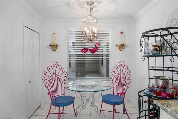 a view of a dining room with furniture and a chandelier