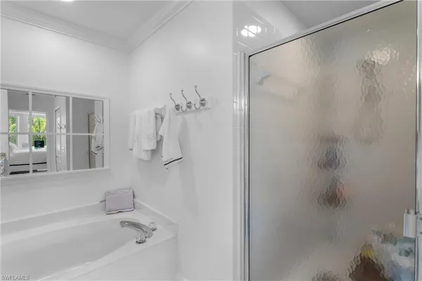 a bathroom with a bathtub and a shower