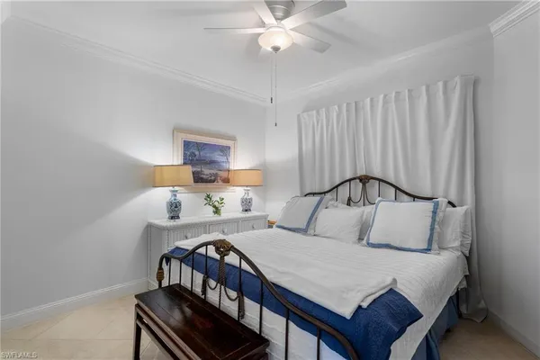 a bedroom with a bed a lamp and a chandelier