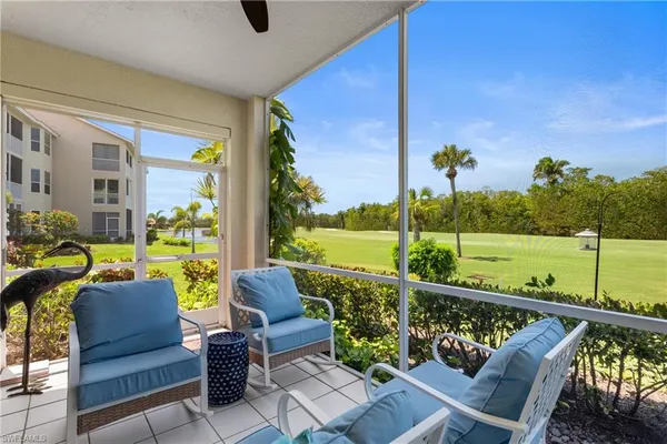 a view of a porch with furniture and garden