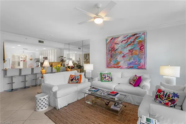 a living room with furniture and a dining table with wooden floor