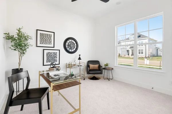 a living room with furniture a dining table and a clock