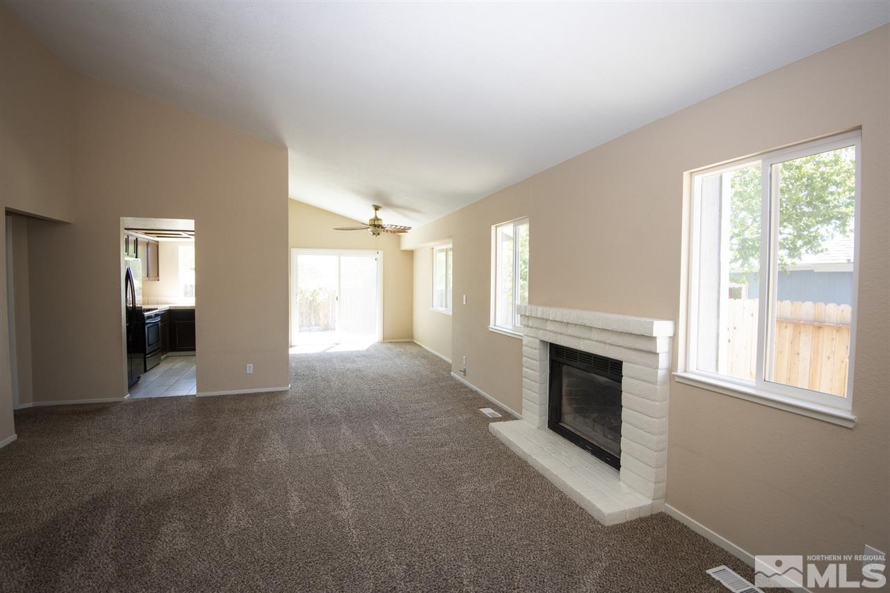 1790 Amarak Way Reno, NV 89523 - Photo 6 of 24 a view of empty room with fireplace and fan