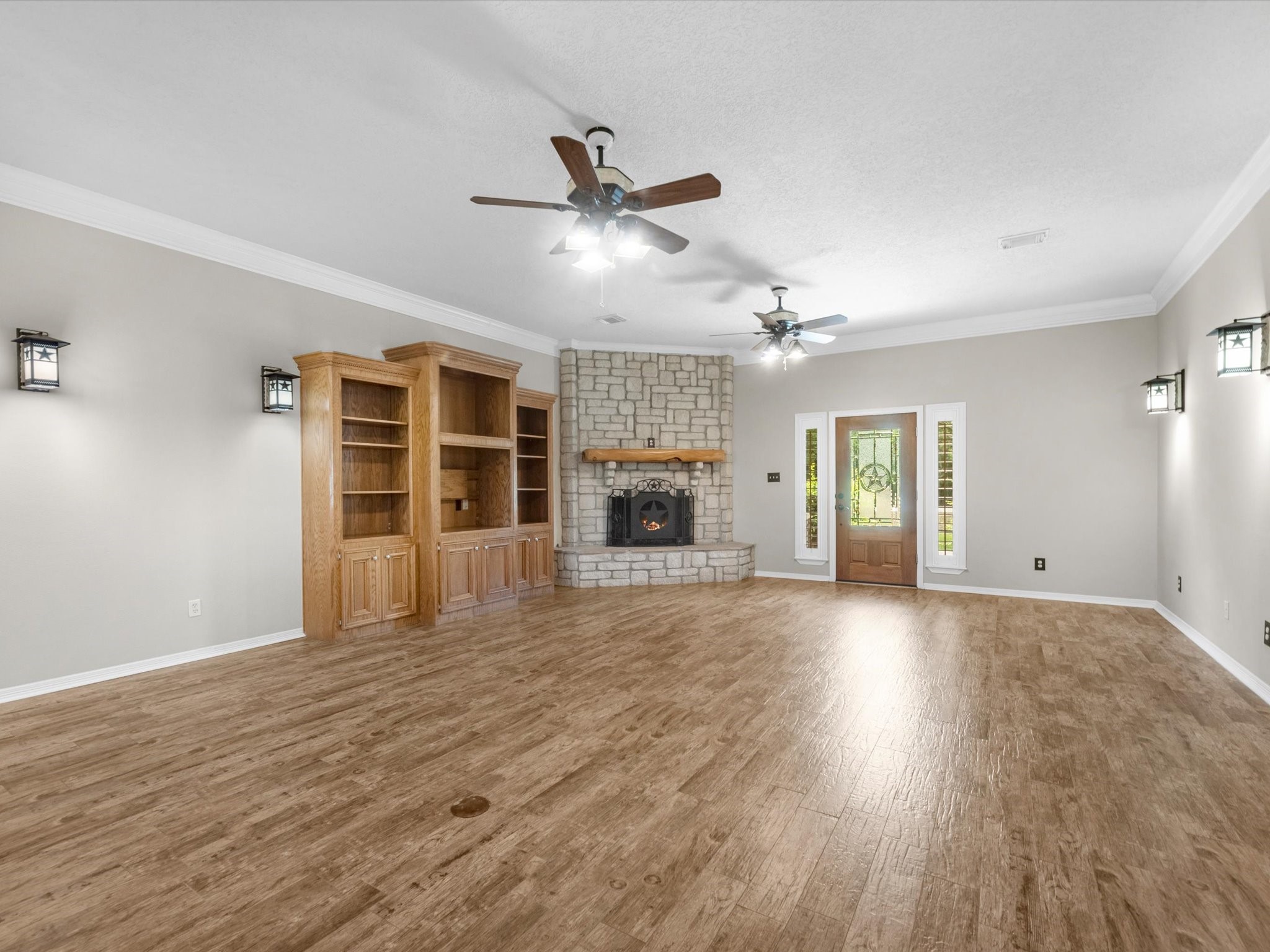 2600 Euell Road Crosby, TX 77532 - Photo 14 of 42 custom built-in entertainment center, crown molding, and wood-tile flooring